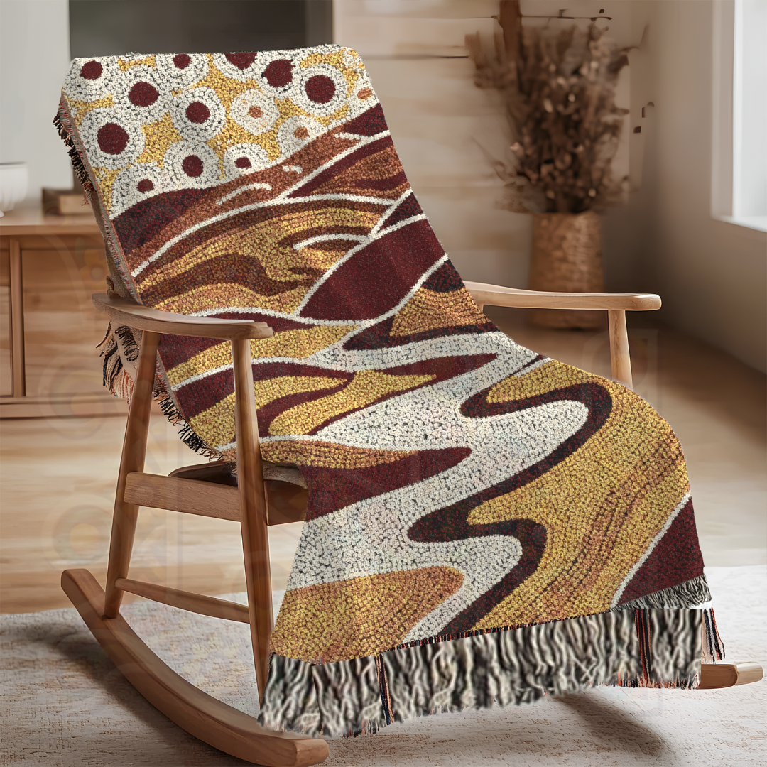 Tribal-inspired woven blanket in earthy tones with abstract patterns, draped over a rocking chair. Made of 100% cotton—perfect as a boho-chic throw, rustic accent, or cultural tapestry wall hanging.