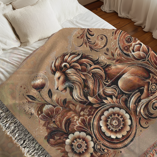 Decorative blanket with a lion and floral design on a bed.